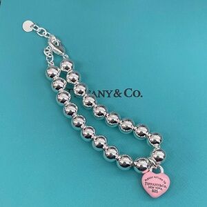 Elegant Tiffany & Co. Silver Bracelet with Pink Charm
